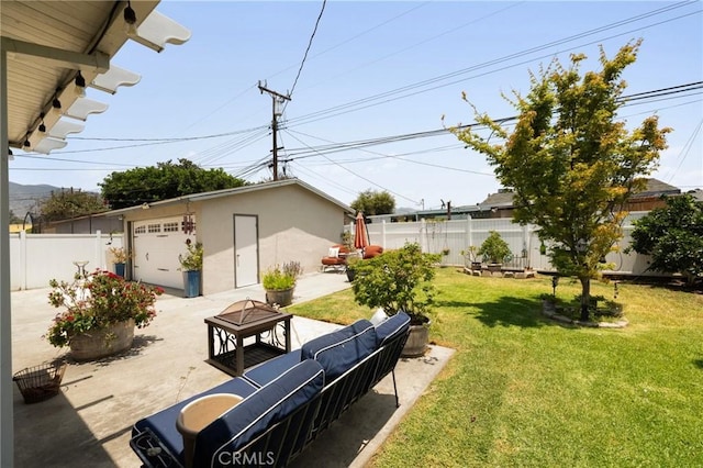 708 S Vecino Dr, Glendora, CA 91740 - fenced yard featuring a fire pit, an outdoor structure, a patio area, driveway, and a detached garage