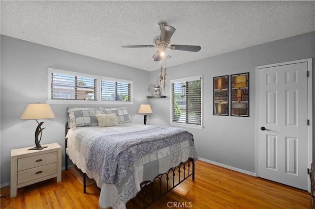 708 S Vecino Dr, Glendora, CA 91740 - bedroom featuring multiple windows, a textured ceiling, wood finished floors, and a ceiling fan