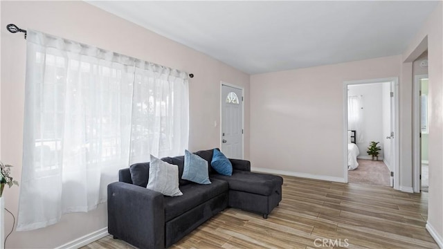 4348 Lima St, Los Angeles, CA 90011 - living area with light wood-style floors and baseboards