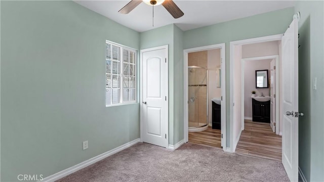 4348 Lima St, Los Angeles, CA 90011 - unfurnished bedroom featuring multiple windows, carpet, connected bathroom, and ceiling fan