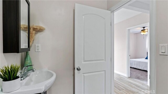 4348 Lima St, Los Angeles, CA 90011 - bathroom with wood finished floors, ceiling fan, and connected bathroom