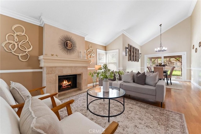 25 Westbrook Ln, Pomona, CA 91766 - living room with a chandelier, wood finished floors, a fireplace, high vaulted ceiling, and ornamental molding