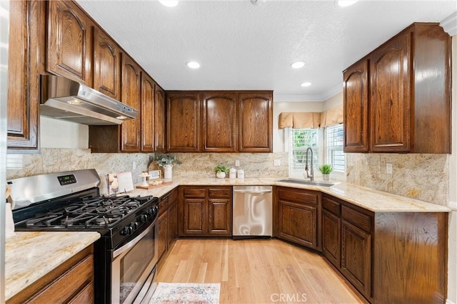 25 Westbrook Ln, Pomona, CA 91766 - kitchen with appliances with stainless steel finishes, under cabinet range hood, light wood-type flooring, crown molding, and recessed lighting