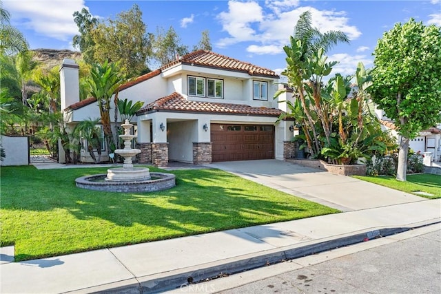 25 Westbrook Ln, Pomona, CA 91766 - mediterranean / spanish-style house with stucco siding, stone siding, a tiled roof, an attached garage, and driveway