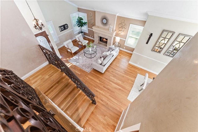 25 Westbrook Ln, Pomona, CA 91766 - living room featuring crown molding, wood finished floors, healthy amount of natural light, and a premium fireplace