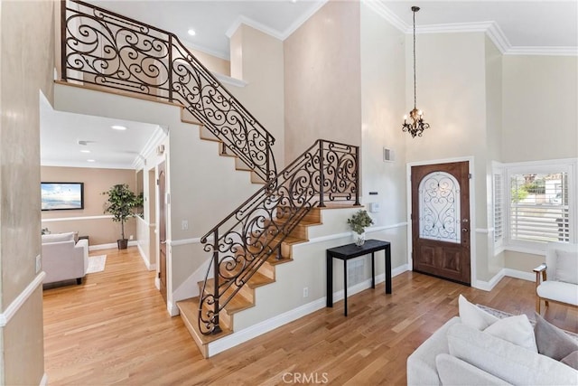 25 Westbrook Ln, Pomona, CA 91766 - foyer with a high ceiling, crown molding, wood finished floors, a chandelier, and stairway