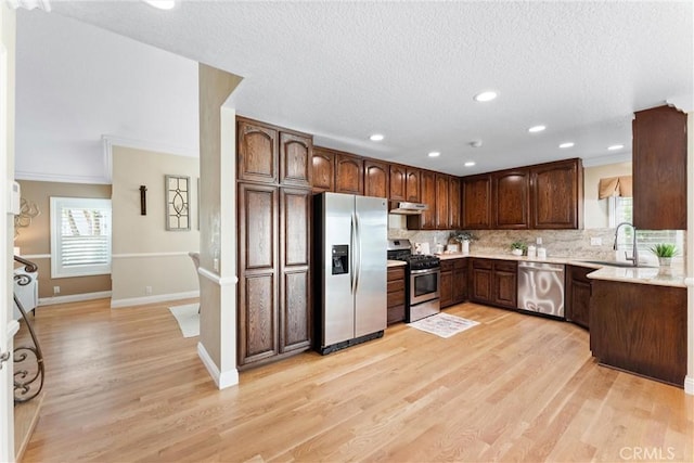 25 Westbrook Ln, Pomona, CA 91766 - kitchen with stainless steel appliances, backsplash, light wood-type flooring, recessed lighting, and ornamental molding