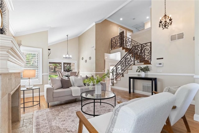 25 Westbrook Ln, Pomona, CA 91766 - living room with a chandelier, ornamental molding, stairs, wood finished floors, and high vaulted ceiling