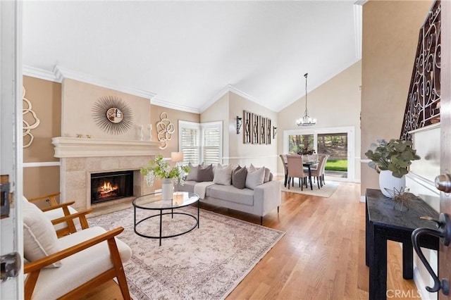 25 Westbrook Ln, Pomona, CA 91766 - living area featuring wood finished floors, a tile fireplace, ornamental molding, high vaulted ceiling, and a chandelier
