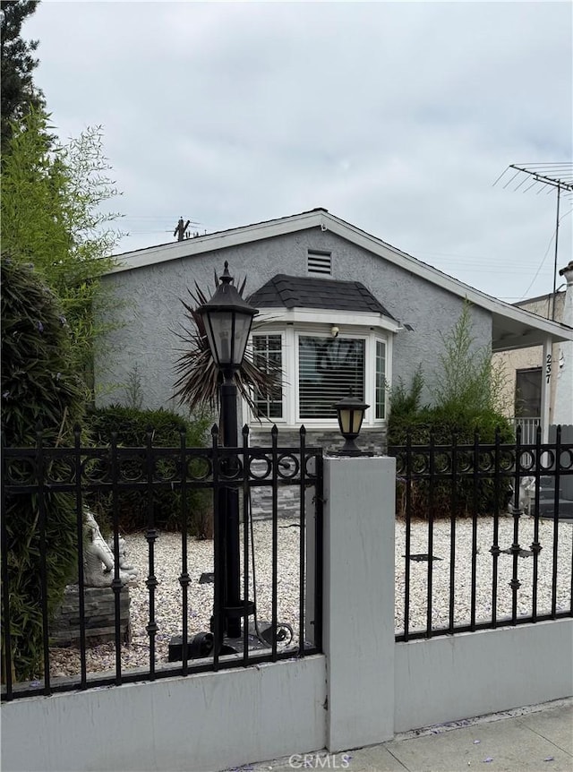 237 E 57th St, Long Beach, CA 90805 - view of front of house featuring a fenced front yard, stucco siding, and a gate