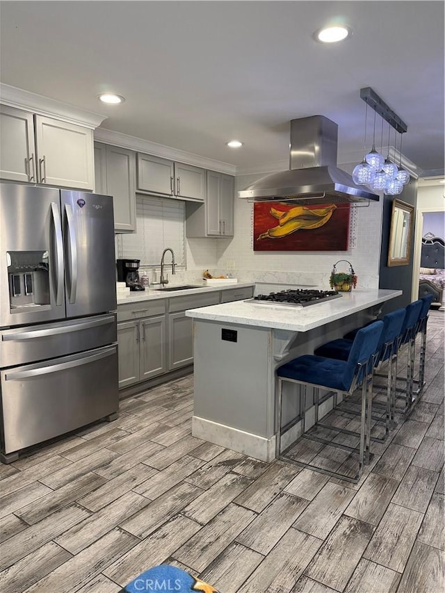 237 E 57th St, Long Beach, CA 90805 - kitchen featuring appliances with stainless steel finishes, island range hood, gray cabinets, light wood finished floors, and ornamental molding