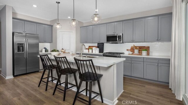 29159 Victoria Beach Blvd, Winchester, CA 92596 - kitchen with stainless steel appliances, gray cabinets, dark wood-type flooring, backsplash, and recessed lighting