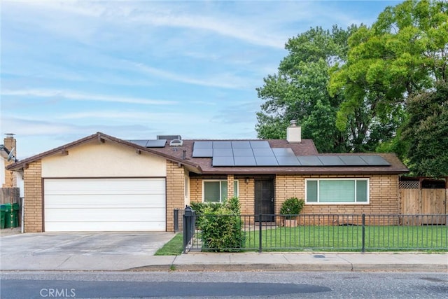 2427 Ceanothus Ave, Chico, CA 95926 - ranch-style home with a fenced front yard, an attached garage, driveway, solar panels, and a chimney