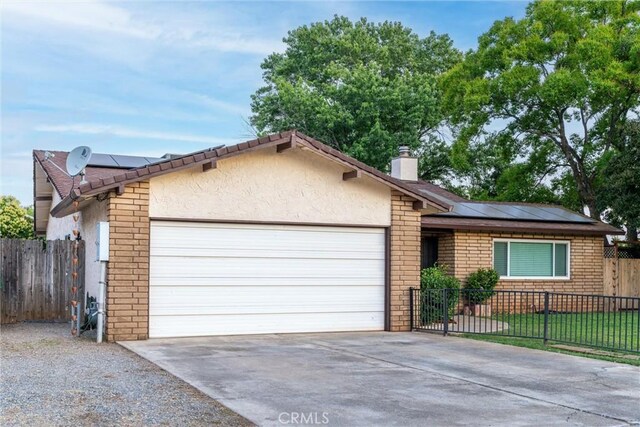 2427 Ceanothus Ave, Chico, CA 95926 - ranch-style home with a garage, stucco siding, driveway, and solar panels