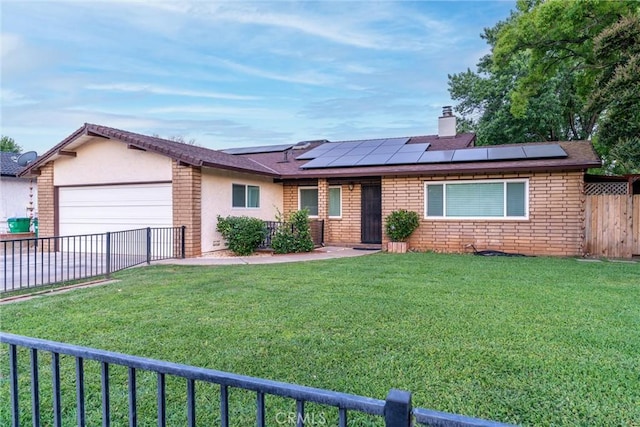 2427 Ceanothus Ave, Chico, CA 95926 - ranch-style house with a garage, roof mounted solar panels, a chimney, and brick siding