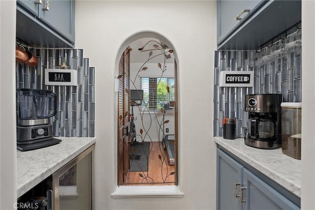 2427 Ceanothus Ave, Chico, CA 95926 - kitchen featuring light stone countertops, gray cabinets, and arched walkways