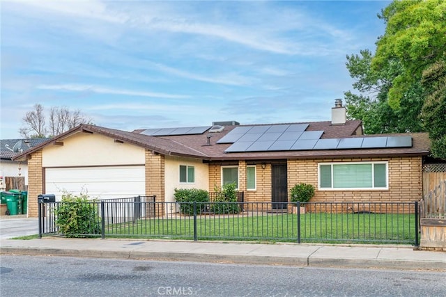 2427 Ceanothus Ave, Chico, CA 95926 - ranch-style house with a fenced front yard, a garage, roof mounted solar panels, a chimney, and roof with shingles