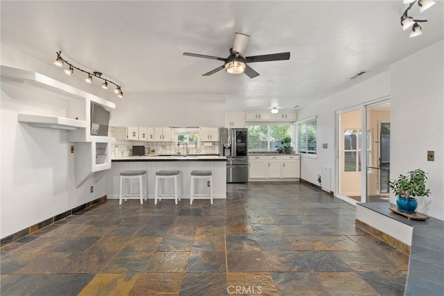 2427 Ceanothus Ave, Chico, CA 95926 - kitchen featuring a peninsula, white cabinets, backsplash, a ceiling fan, and stainless steel refrigerator with ice dispenser