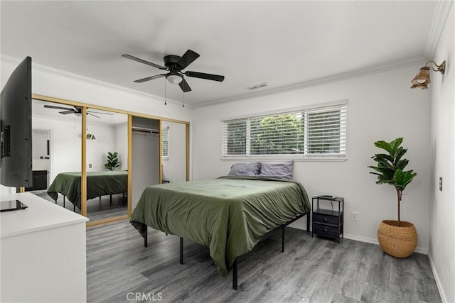 2427 Ceanothus Ave, Chico, CA 95926 - bedroom featuring wood finished floors, a closet, crown molding, and a ceiling fan