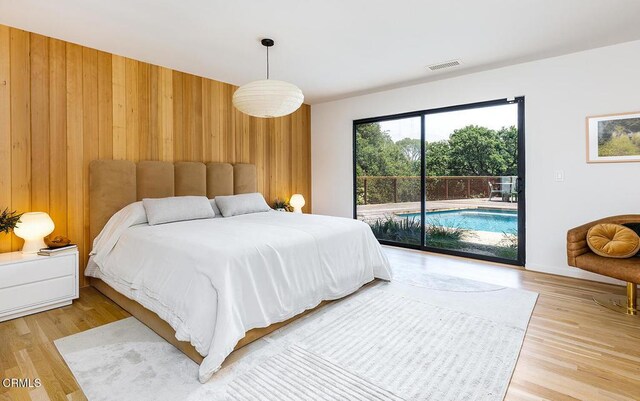 808 Inverness Dr, La Canada Flintridge, CA 91011 - bedroom featuring access to exterior, wooden walls, and light wood-type flooring