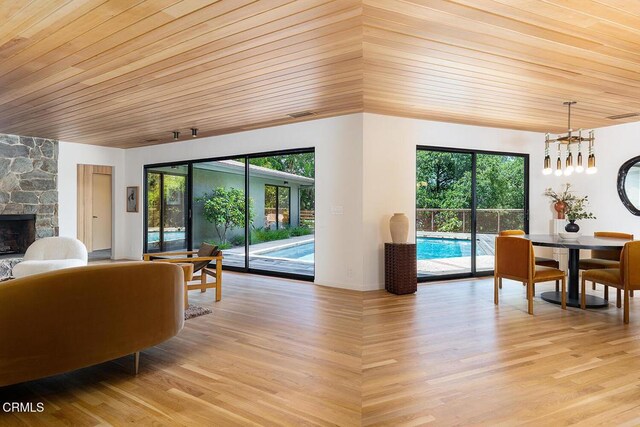808 Inverness Dr, La Canada Flintridge, CA 91011 - living area with wood ceiling, a chandelier, plenty of natural light, light wood-type flooring, and a stone fireplace