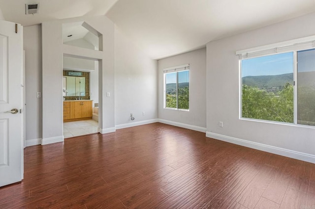 14136 Capewood Ln, San Diego, CA 92128 - spare room featuring light wood-type flooring and lofted ceiling