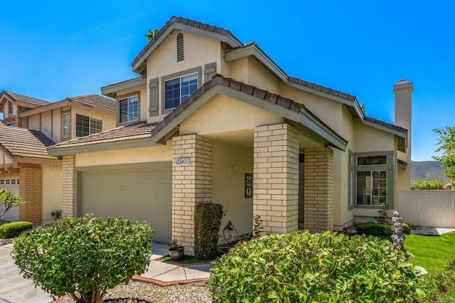 14136 Capewood Ln, San Diego, CA 92128 - traditional-style house with brick siding, stucco siding, an attached garage, and a chimney