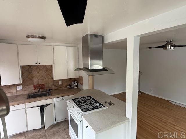 4496 47th St, San Diego, CA 92115 - kitchen with wall chimney exhaust hood, white appliances, white cabinets, and tasteful backsplash