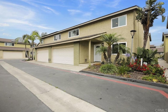 814 Hollister St Unit B, Otay Mesa, CA 92154 - townhome / multi-family property featuring stucco siding, a garage, and brick siding