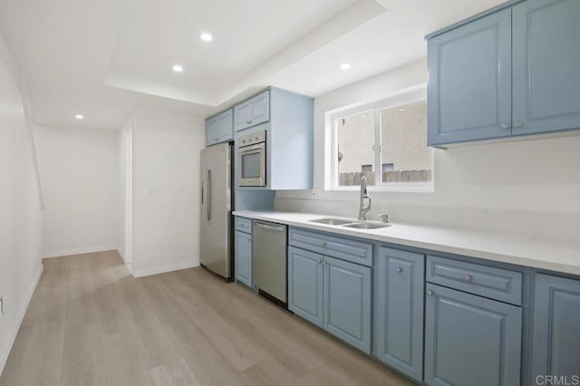 814 Hollister St Unit B, Otay Mesa, CA 92154 - kitchen featuring appliances with stainless steel finishes, light countertops, blue cabinets, light wood finished floors, and recessed lighting