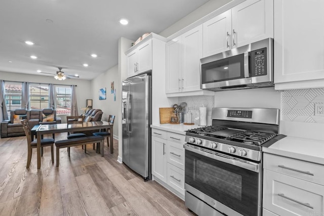 4376 Pacifica Dr Unit 2, Oceanside, CA 92056 - kitchen featuring stainless steel appliances, recessed lighting, ceiling fan, decorative backsplash, and white cabinets