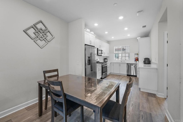 4376 Pacifica Dr Unit 2, Oceanside, CA 92056 - dining room with light wood finished floors and recessed lighting