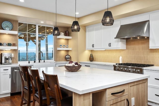 7661 Sitio Algodon, Carlsbad, CA 92009 - kitchen featuring wall chimney range hood, open shelves, a kitchen island, decorative backsplash, and light stone countertops