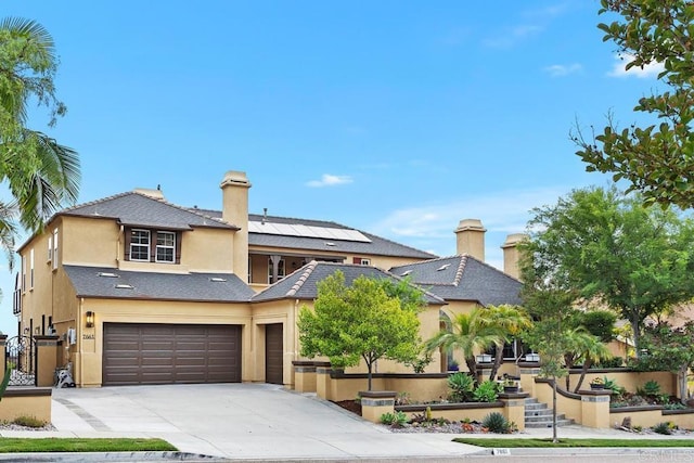 7661 Sitio Algodon, Carlsbad, CA 92009 - traditional-style home featuring stucco siding, roof mounted solar panels, driveway, an attached garage, and a chimney