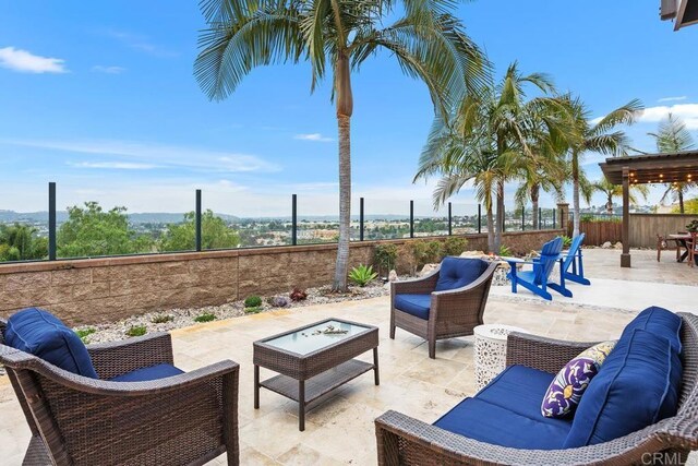 7661 Sitio Algodon, Carlsbad, CA 92009 - fenced backyard with an outdoor living space and a patio