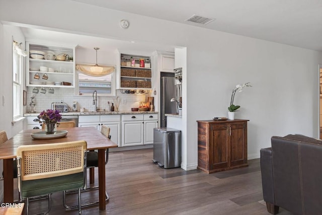 310 N Fulton St, Ojai, CA 93023 - kitchen featuring open shelves, white cabinetry, dark wood-style floors, decorative backsplash, and light stone counters