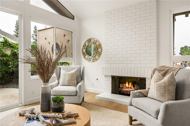19795 Futura Dr, Yorba Linda, CA 92886 - sitting room with vaulted ceiling, light wood-style floors, and a fireplace