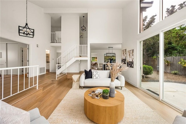 19795 Futura Dr, Yorba Linda, CA 92886 - living room with a towering ceiling, wood finished floors, stairway, and a chandelier