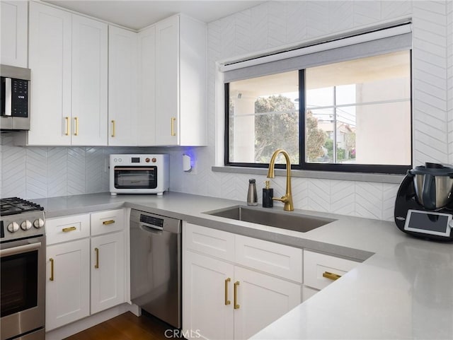 22477 Kent, Torrance, CA 90505 - kitchen with stainless steel appliances, white cabinetry, tasteful backsplash, and light countertops