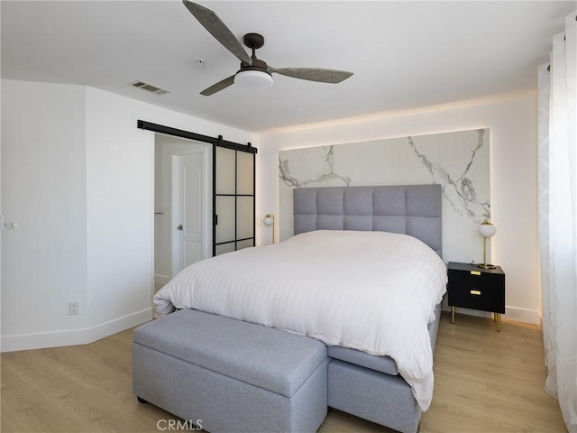 22477 Kent, Torrance, CA 90505 - bedroom featuring light wood-style floors, a barn door, and ceiling fan