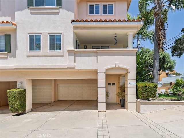 22477 Kent, Torrance, CA 90505 - mediterranean / spanish home with stucco siding, a balcony, an attached garage, a tile roof, and driveway