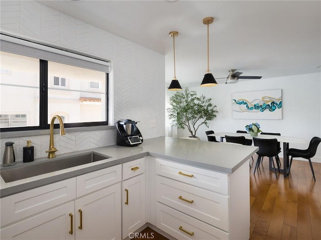 22477 Kent, Torrance, CA 90505 - kitchen featuring white cabinets, a peninsula, pendant lighting, backsplash, and wood finished floors