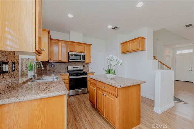 24646 Maple Ln, Harbor City, CA 90710 - kitchen with appliances with stainless steel finishes, decorative backsplash, light wood-style floors, light stone countertops, and recessed lighting