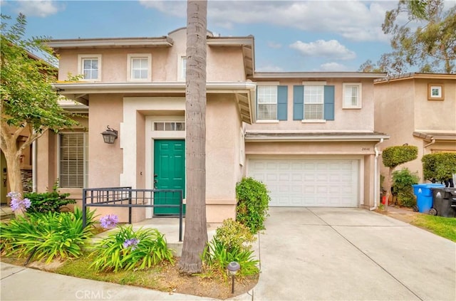 24646 Maple Ln, Harbor City, CA 90710 - view of front of home with stucco siding, a garage, and driveway