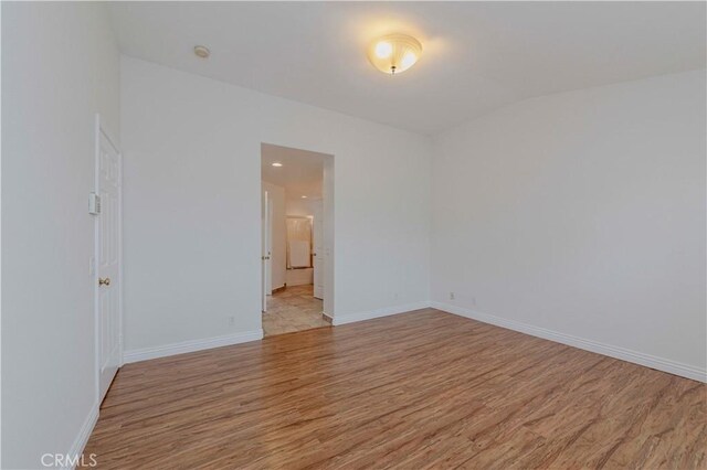 24646 Maple Ln, Harbor City, CA 90710 - unfurnished room featuring light wood-style flooring and lofted ceiling