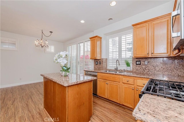 24646 Maple Ln, Harbor City, CA 90710 - kitchen with stainless steel appliances, a center island, tasteful backsplash, light wood finished floors, and recessed lighting