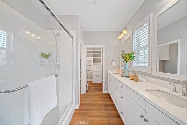 89 Overbrook, Irvine, CA 92620 - bathroom with a stall shower, double vanity, plenty of natural light, and wood finished floors