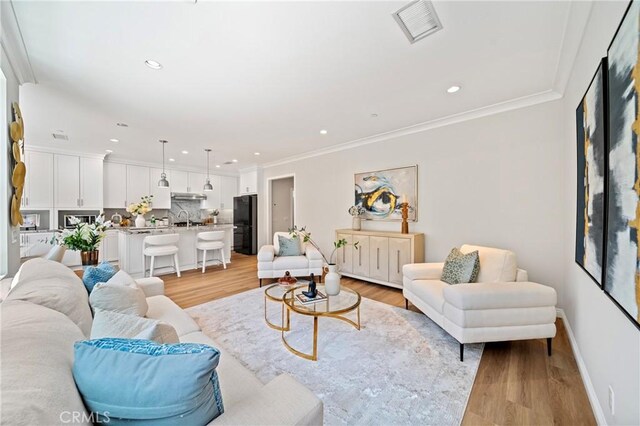 89 Overbrook, Irvine, CA 92620 - living room with light wood-type flooring, recessed lighting, and crown molding