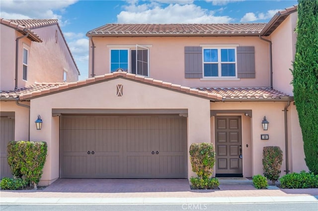 89 Overbrook, Irvine, CA 92620 - view of front facade with a tiled roof, stucco siding, and driveway