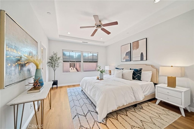 89 Overbrook, Irvine, CA 92620 - bedroom featuring light wood-style floors, a tray ceiling, recessed lighting, and ceiling fan